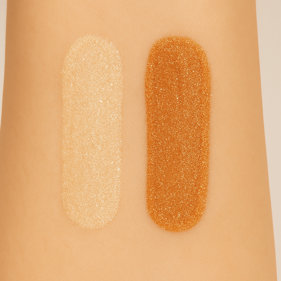 Swatches of Lucky Chick Dawn Glow and Radiant Glow Fruit-Infused Illuminizers on skin showing light champagne and bronze shimmer shades.