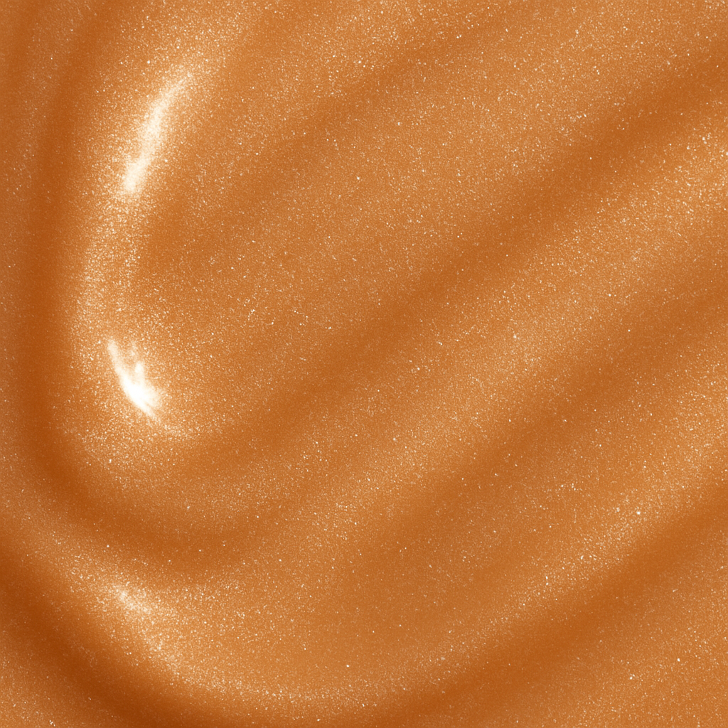 Smooth bronze cream texture of Lucky Chick Radiant Glow Fruit-Infused Illuminizer with luminous shimmer finish.