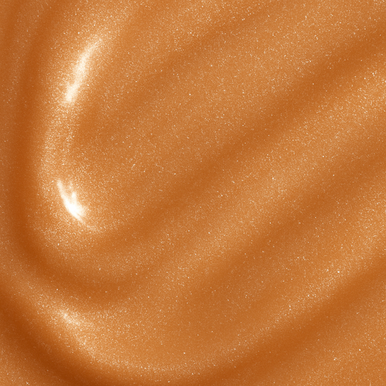 Smooth bronze cream texture of Lucky Chick Radiant Glow Fruit-Infused Illuminizer with luminous shimmer finish.