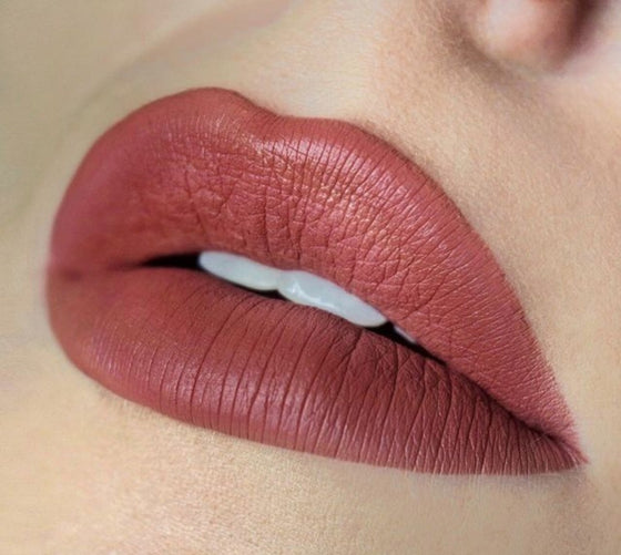 Close-up of lips wearing Lucky Chick Creamy Matte Lipstick in Paradise, showing the rosy nude shade with a smooth semi-matte finish.
