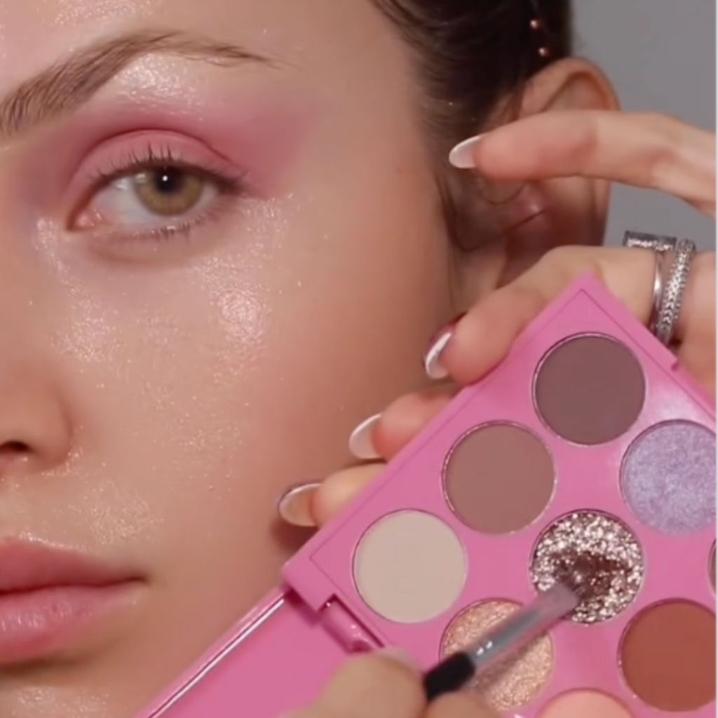 Model applying gold shimmer shade from Lucky Chick Daydreams Eyeshadow Palette to eyelid