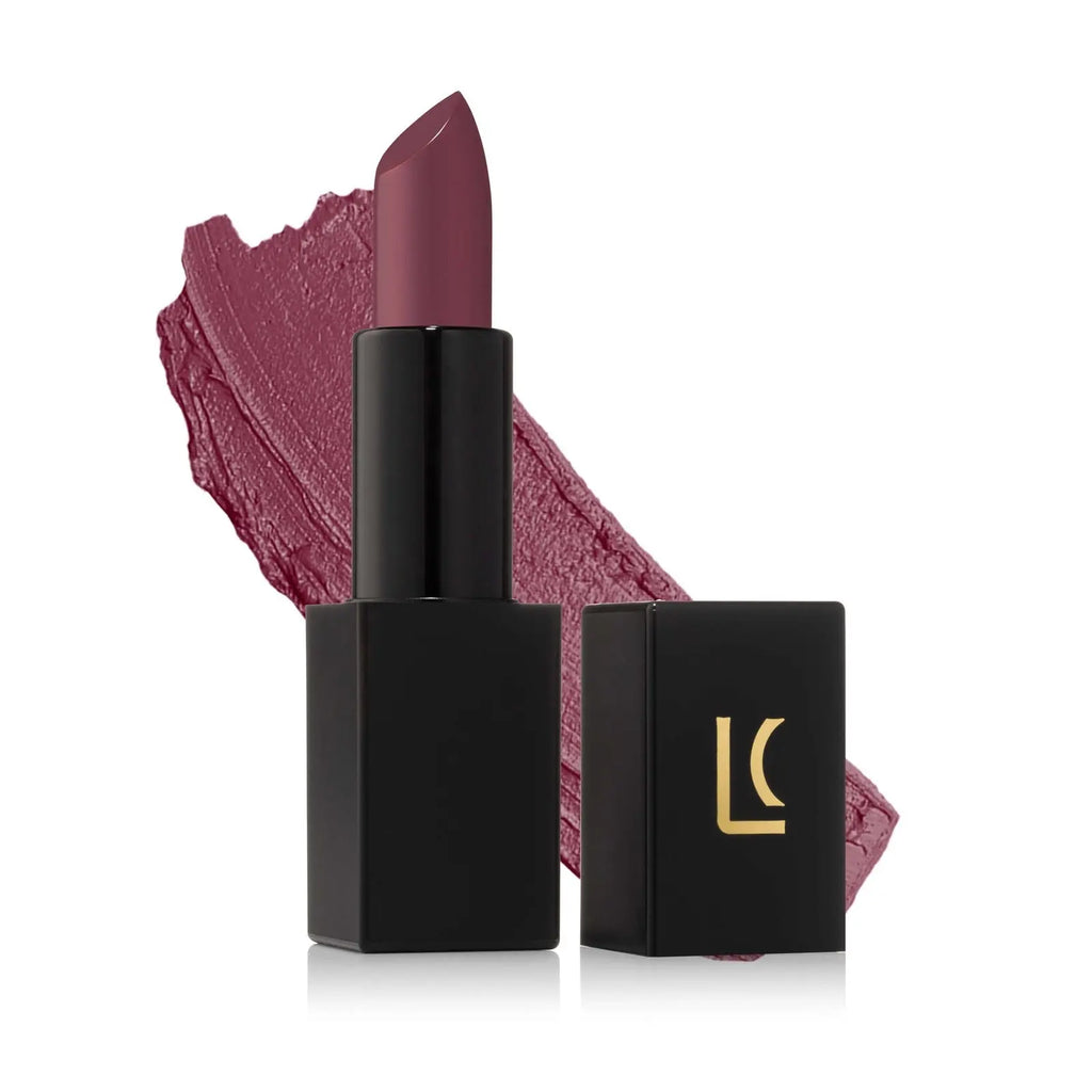 Lucky Chick Creamy Matte Lipstick in Fierce shade – hydrating long wear vegan lipstick. Lipstick swatch in the background.